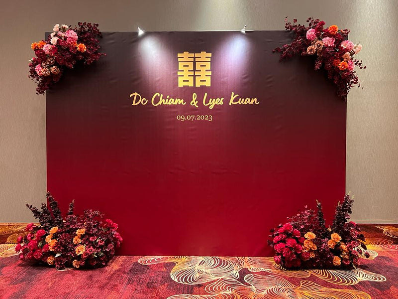 Simple event decoration with a clean floral backdrop