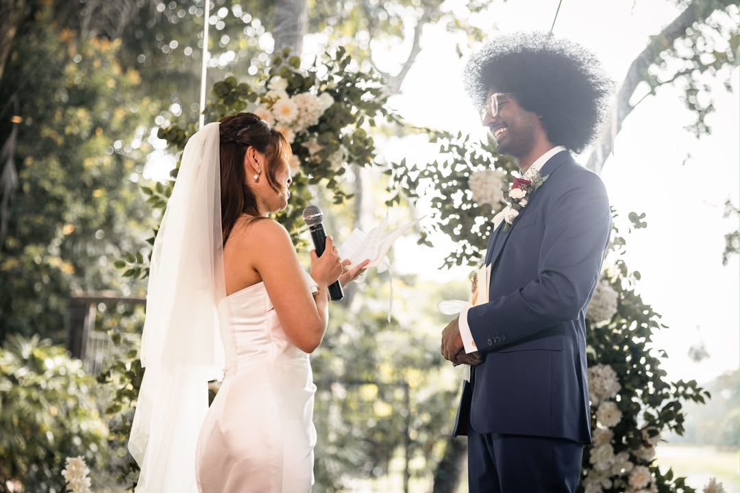 Outdoor wedding ceremony floral arch with white and green flowers